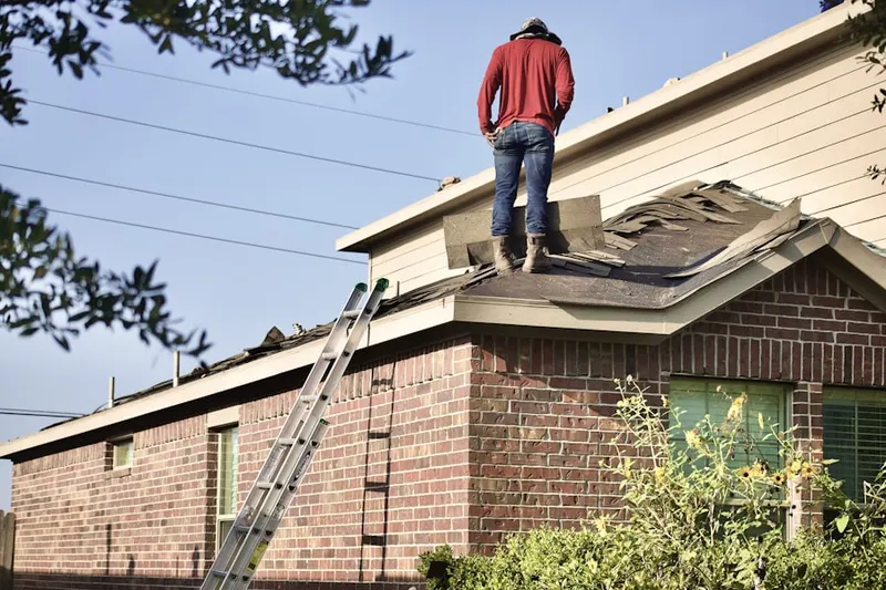 Professional roofer working on a residential roof in West Salem